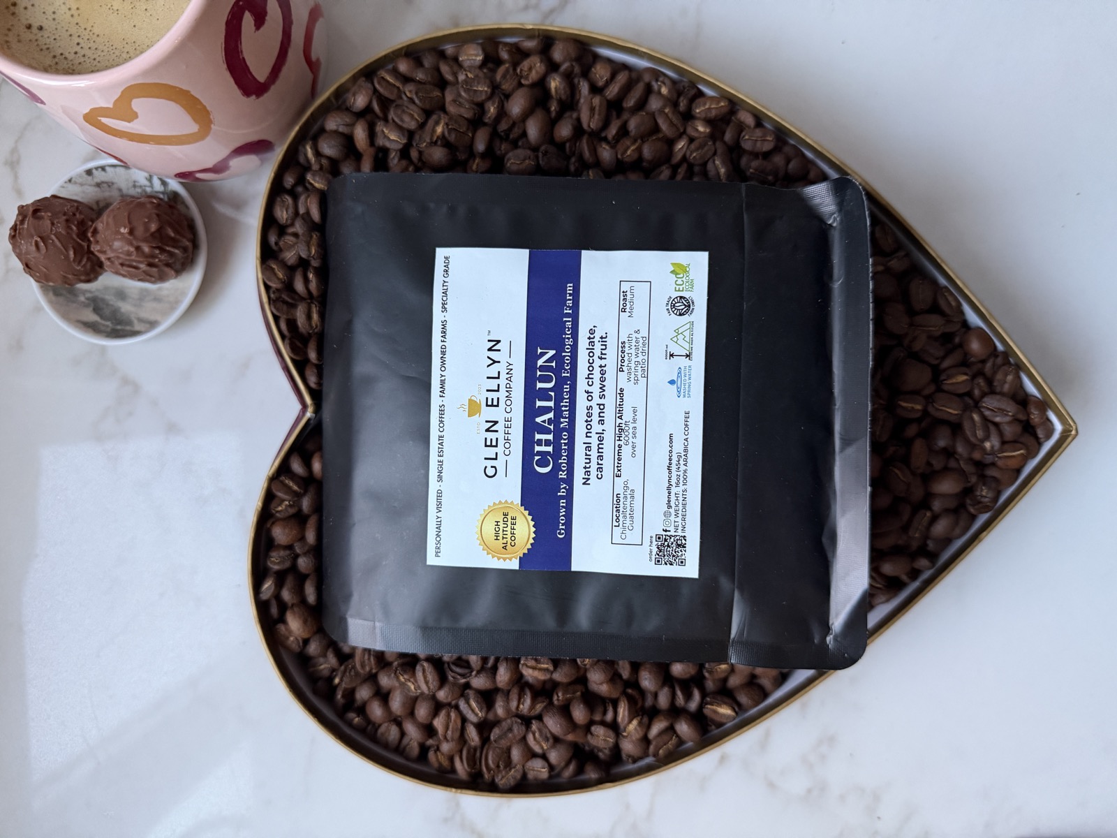Glen Ellyn Coffee Valentine's Day bag on a heart-shaped tray of beans
